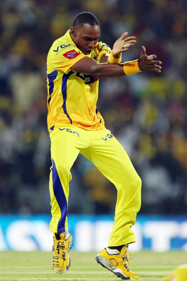 a man in yellow and blue uniform throwing a ball