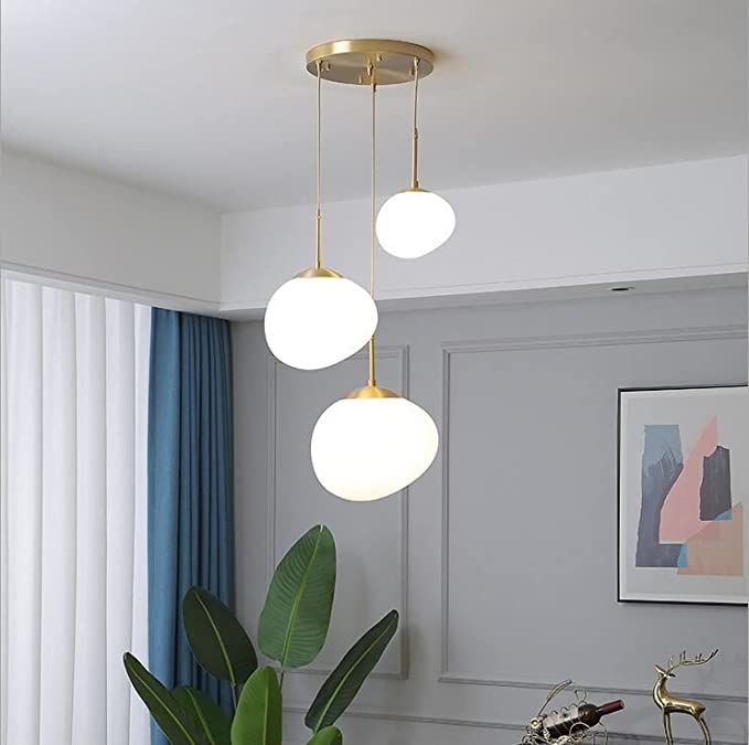 three lights hanging from the ceiling in a living room