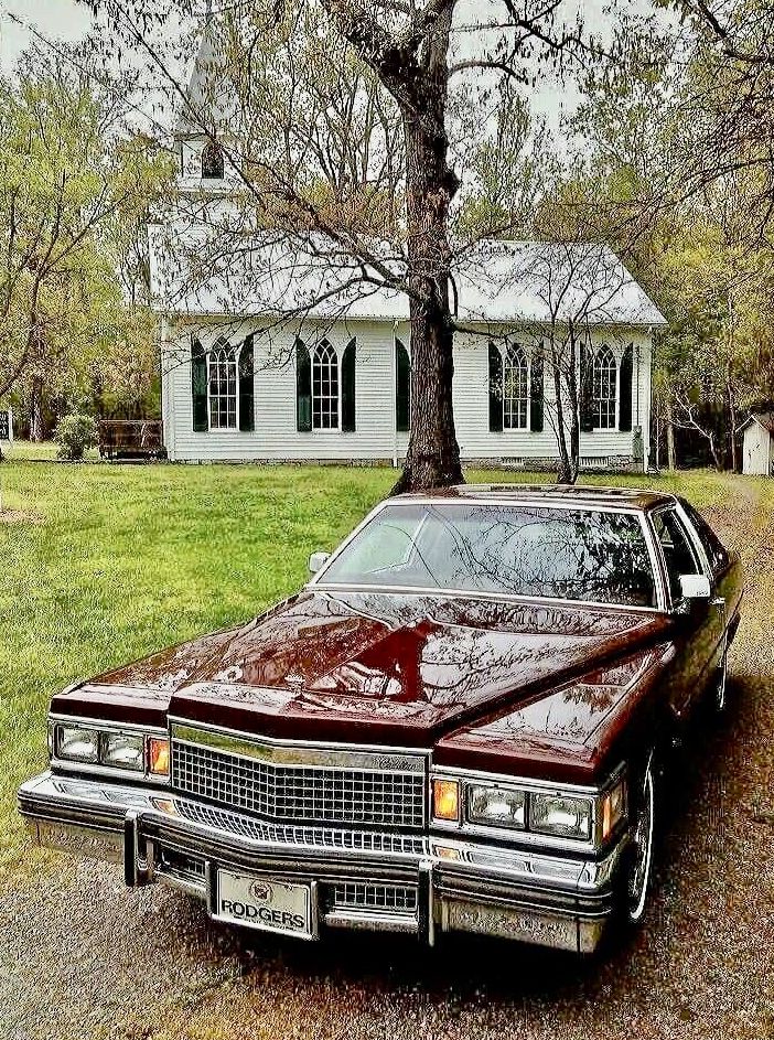 an old car parked in front of a house