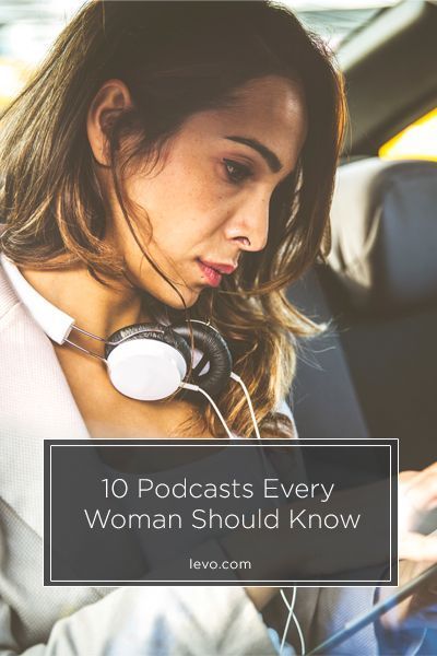 a woman wearing headphones sitting in the back seat of a car