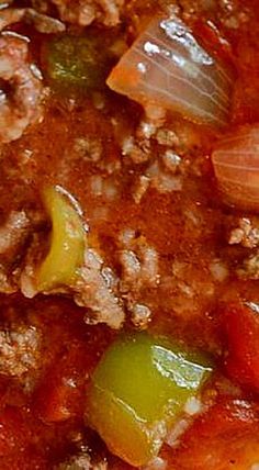 a close up view of some food in a bowl with broth and peppers on it