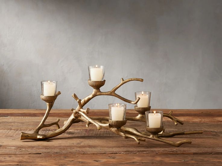 a candle holder made out of branches and candles