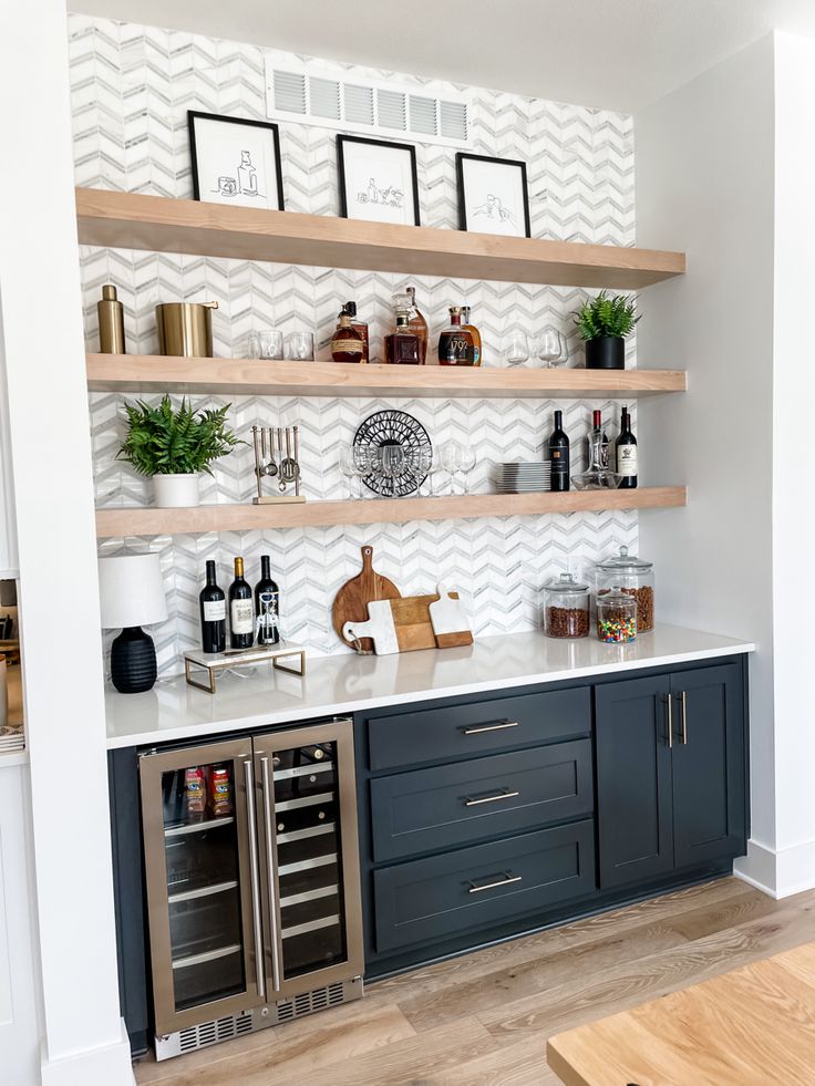 a kitchen with open shelving and wine bottles on the shelves