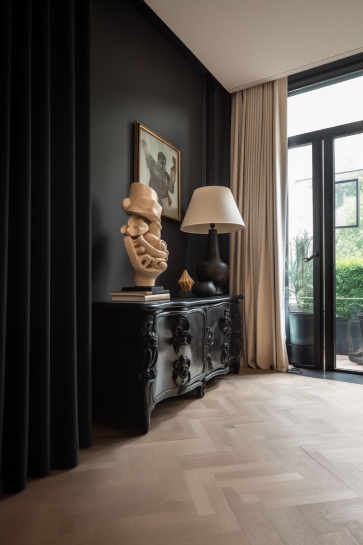 a black and white living room with a lamp on the side table next to it