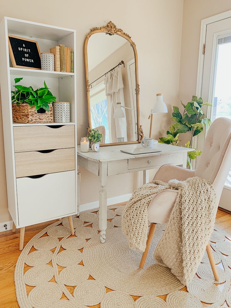 a white desk with a mirror, chair and potted plants on top of it