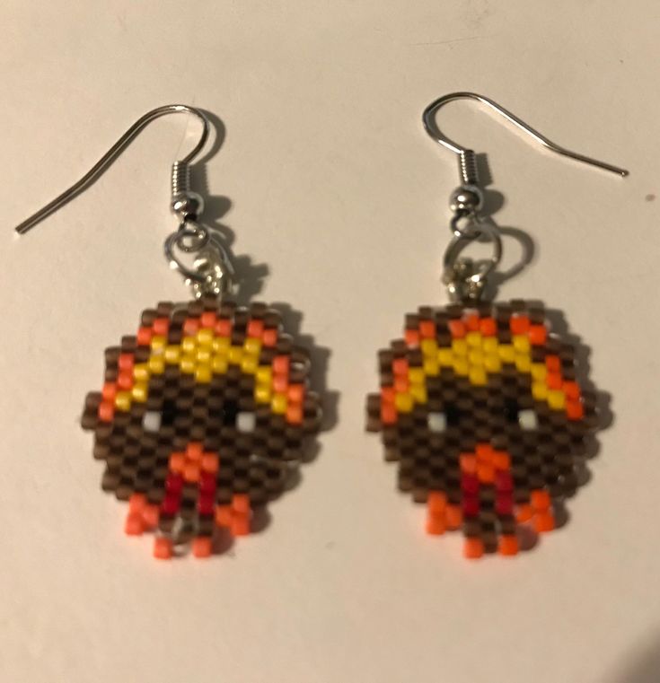 a pair of earrings made out of legos