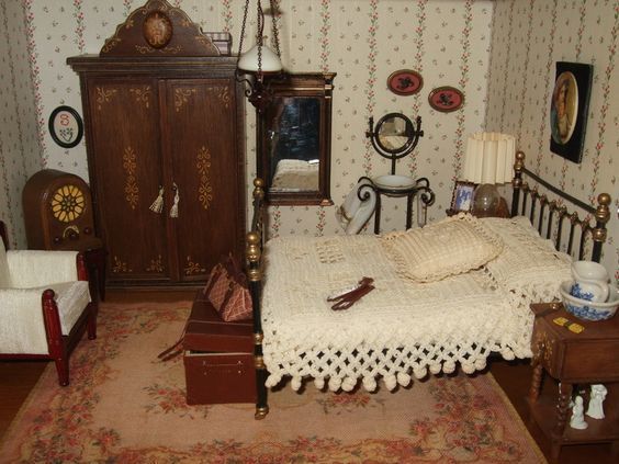 a doll house bedroom with bed, dresser and armoire in the middle of the room