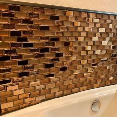 a bath tub sitting next to a tiled wall