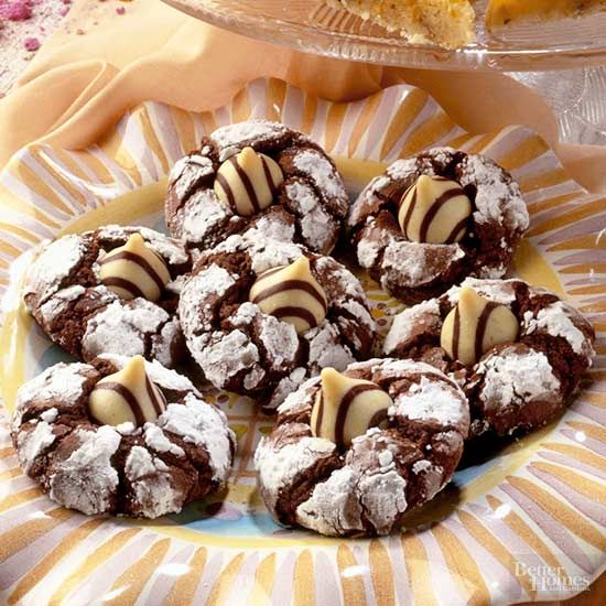 chocolate crinkle cookies with white frosting on a plate