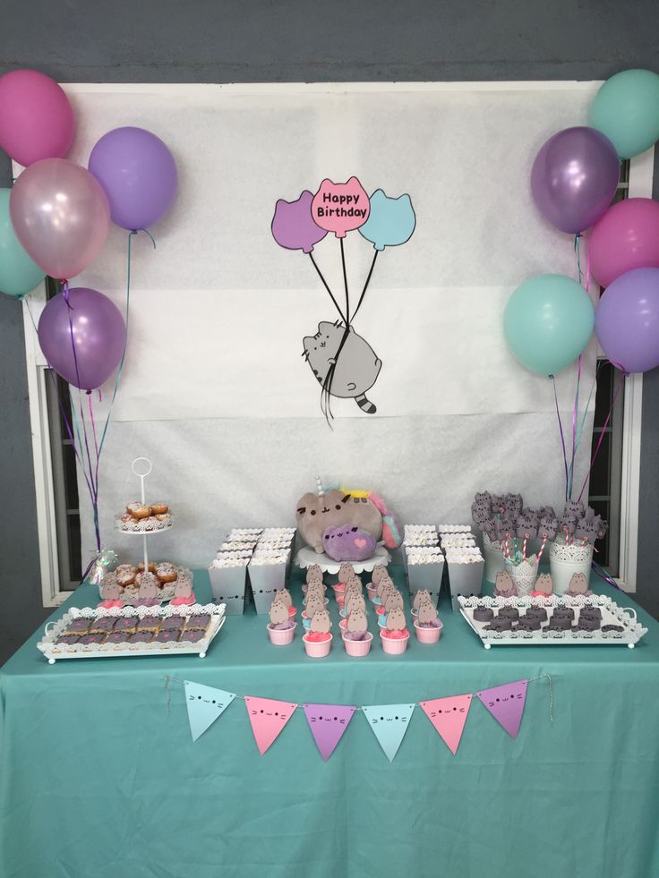 a table topped with lots of desserts and balloons