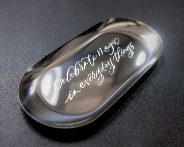 a spoon with writing on it sitting on a table