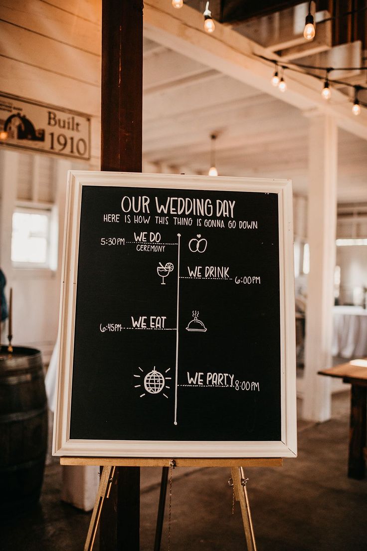 a chalkboard sign that says our wedding day