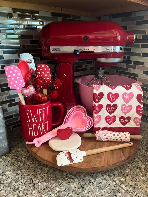 a kitchen counter with red appliances and heart shaped decorations on it, including an electric mixer