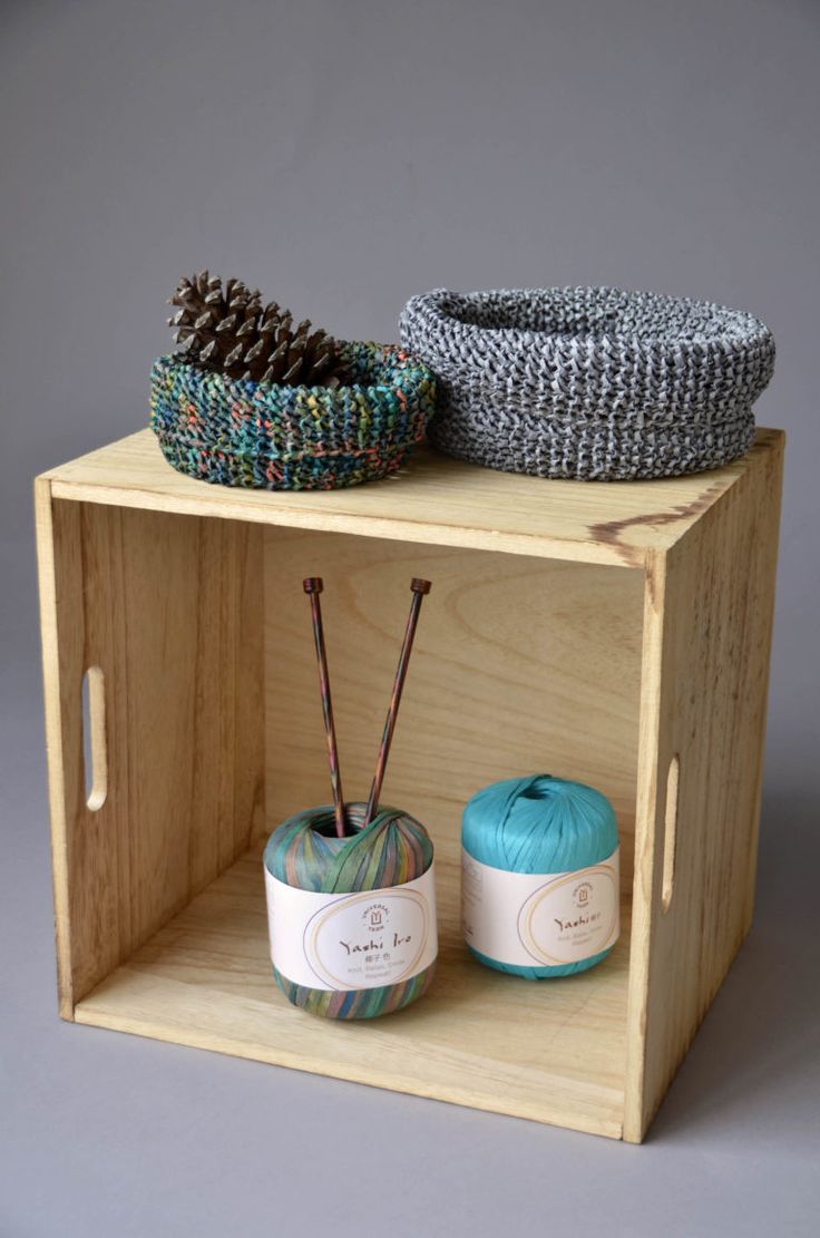 two yarns are sitting on a wooden shelf