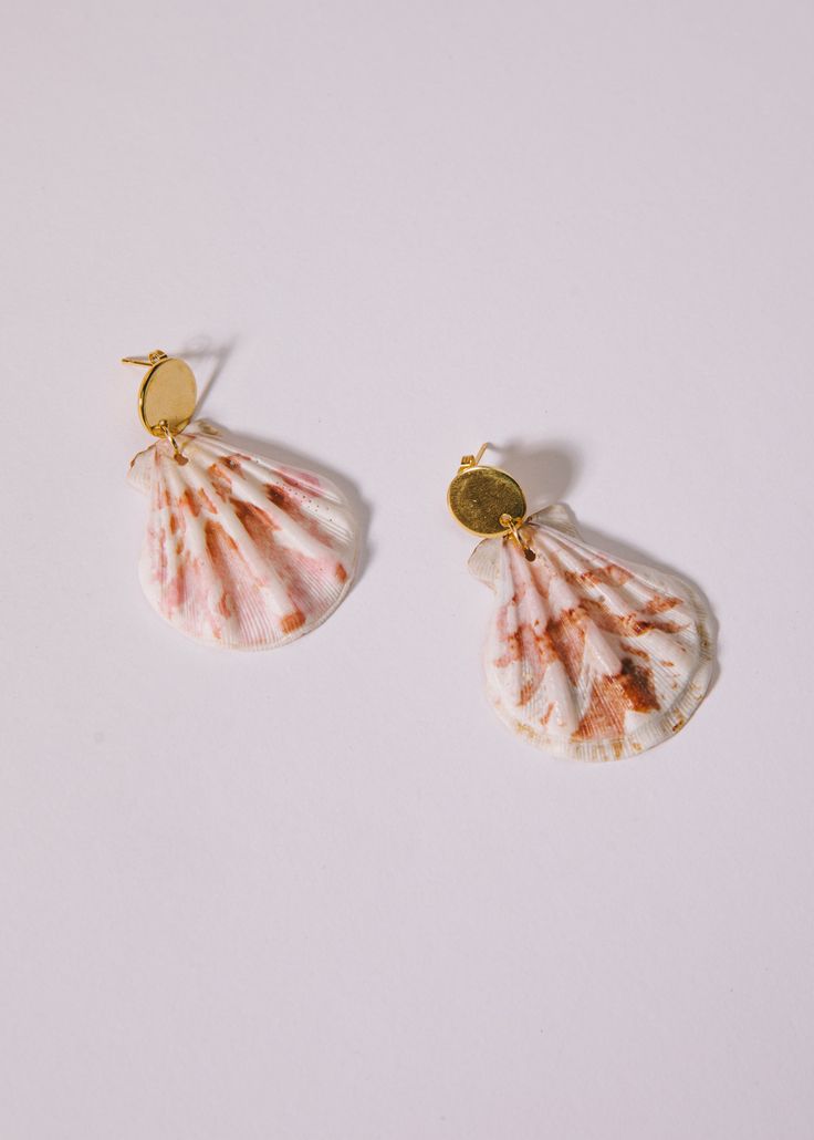 Bring a touch of seaside charm to any outfit with these gorgeous natural shell earrings. Perfect for summer events, these scalloped shell earrings are sure to make a lasting impression. Please note: shells are natural and may vary in color and size. Beachy Shell Dangle Earrings, Summer Ocean-inspired Shell-shaped Earrings, Summer Gift Shell-shaped Earrings, Ocean-inspired Shell Earrings With Ear Wire, Vacation Shell-shaped Earrings With Ear Wire, Ocean-inspired Shell Earrings, Coral Earrings For Beach Summer, Coral Earrings For Beach And Summer, Beach Earrings Made Of Mother Of Pearl