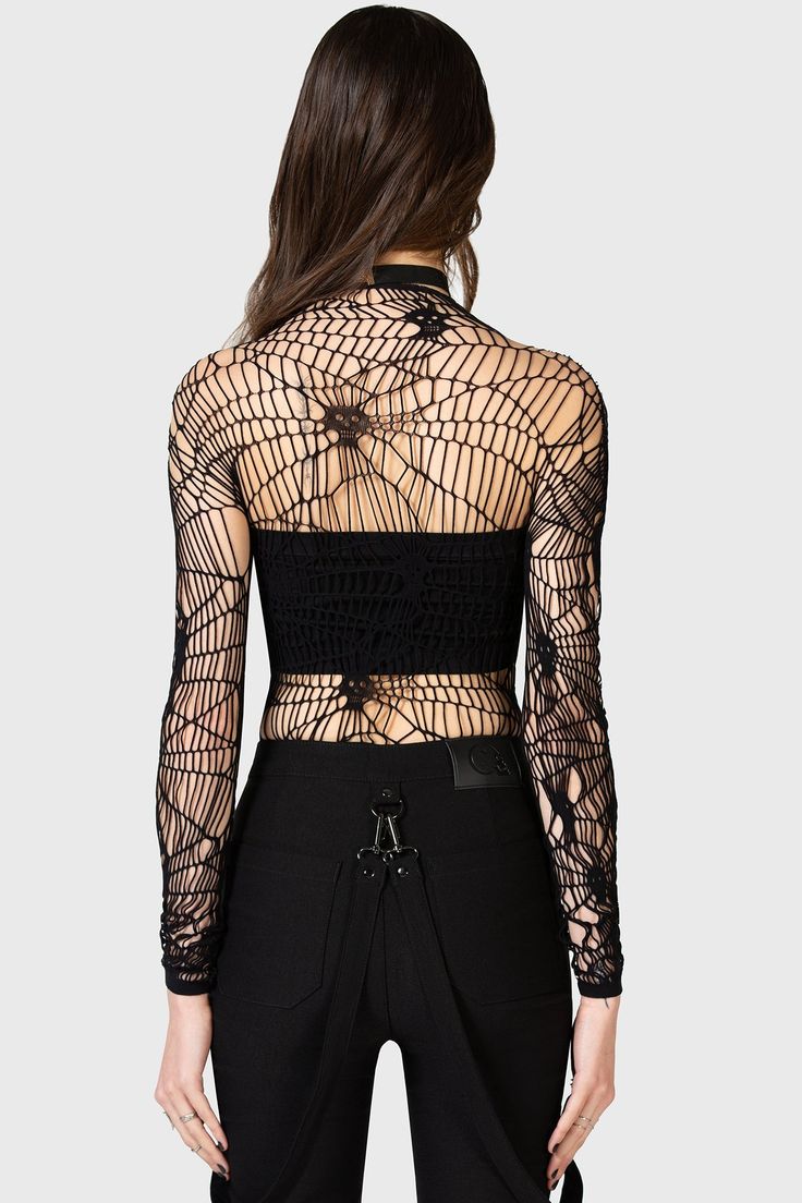 WEBS GRASP.- Soft, stretch fishnet.- Statement web style net with interwoven skulls.- Long sleeves.- Fitted.With KIHILIST branding, 94% Polyamide, 6% Elastane.Hand wash cold (30°c) / Do not bleach / Do not tumble dry / Iron at low temperature / Do not dry clean. Imported. Black Sheer Mesh Top For Festival, Black Stretch Gothic Mesh Top, Edgy Fishnet Mesh Top For Night Out, Punk Style Mesh Top For Clubbing, Stretch Mesh Top With Open Knit, Fitted Hollow Out Mesh Top For Party, Gothic Black Stretch Mesh Top, Stretch Open Knit Mesh Top, Black Fitted Mesh Top For Festivals