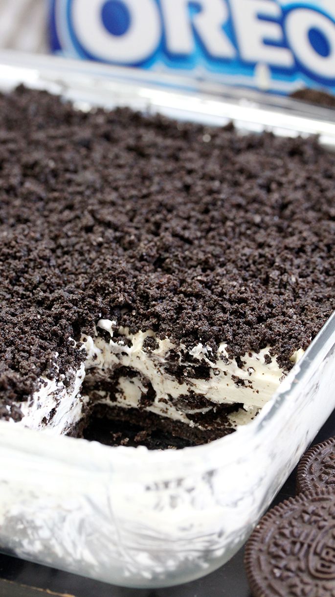 an oreo cookie cake with white frosting and chocolate chips on the side, ready to be eaten