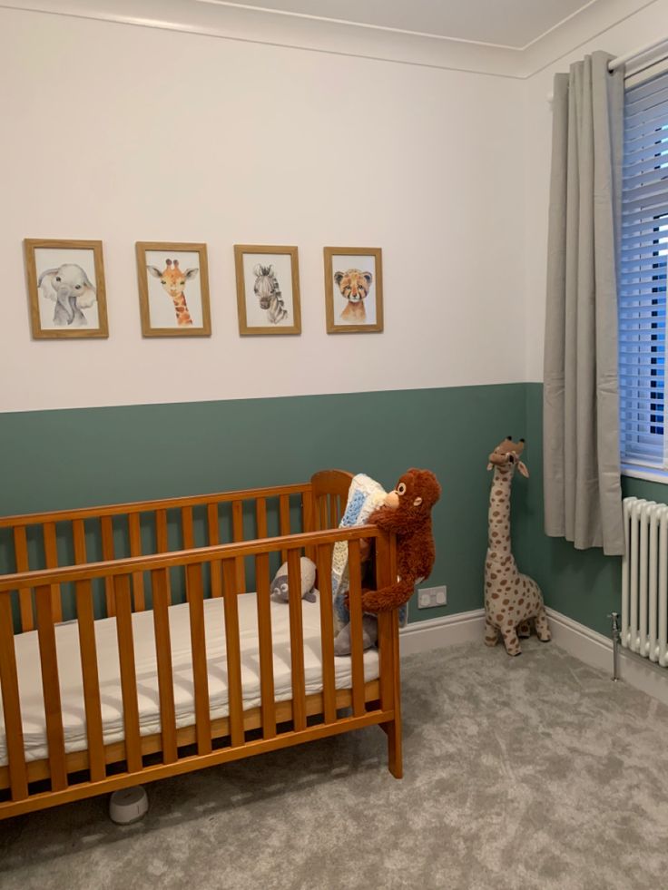 a baby's room with a crib, rocking horse and pictures on the wall