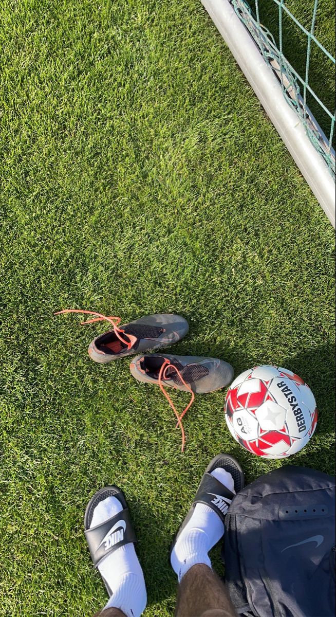 a soccer ball and some shoes on the grass