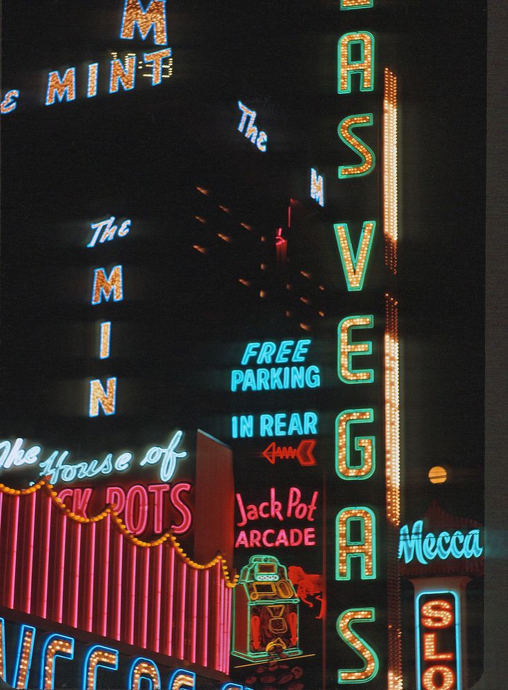 neon signs on the side of a building in las vegas, nv at night