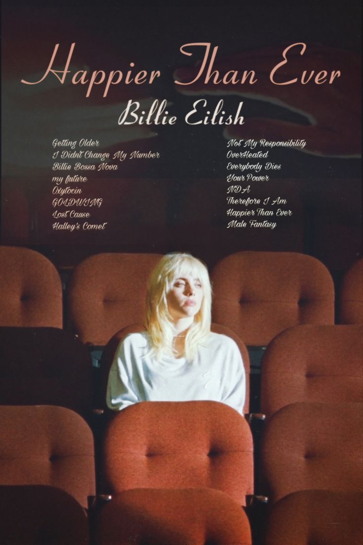 a woman sitting in a red chair next to an empty theater seat with the words, happier than ever written on it