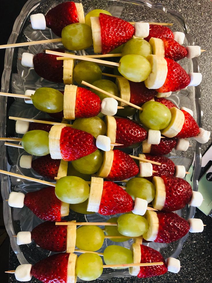 fruit skewers with marshmallows, strawberries and grapes on them