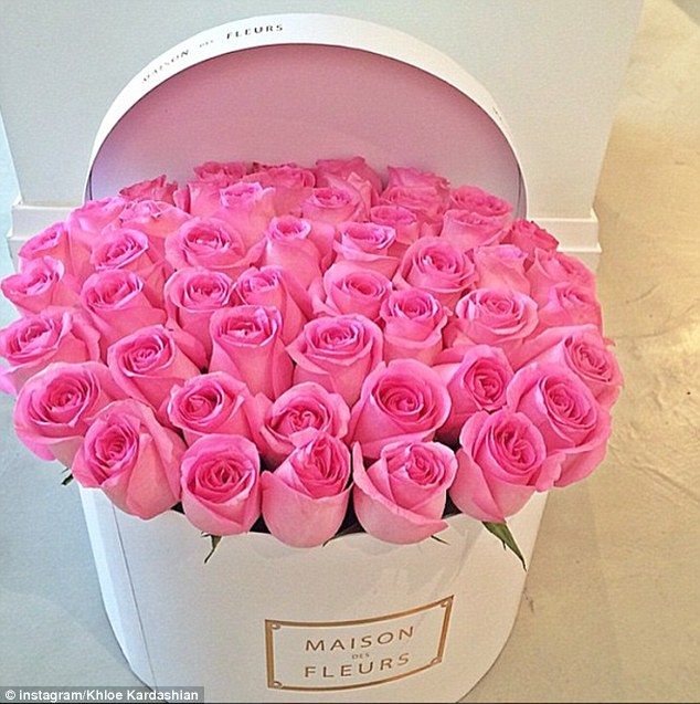 a white box with pink roses in it