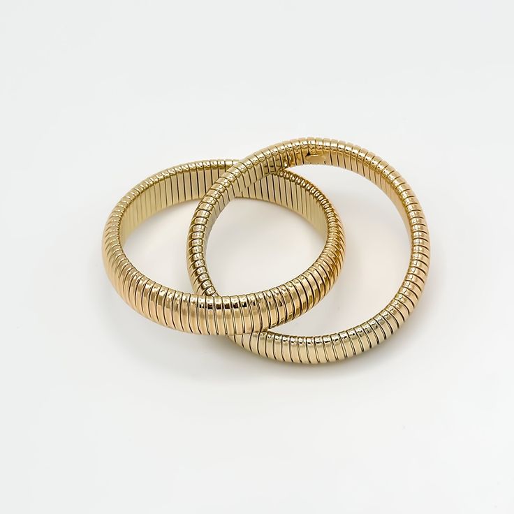 Boost your style with the Porter Bangle Stack, a stunning 18K gold and rhodium filled bracelet featuring an intertwined 14mm wide coil design. This sophisticated piece is both unique and versatile, perfect for the confident, fashion-forward woman. Meticulously crafted for comfort and durability, it's the perfect accessory you'll reach for every day. Bracelets come together 70mm in diameter stretch bangle design 18k gold filled demi-fine Elegant Spiral Bracelets For Formal Occasions, Elegant Metal Bracelet, Elegant Metal Bracelets With Flexible Fit, Elegant Gold Stretch Bracelet For Formal Occasions, Elegant Gold Stretch Bracelet, Elegant Gold Stretch Bracelet With Jubilee Style, Gold Jubilee Stretch Bracelet For Formal Occasions, Slinky Flexible Bangle Bracelet, Elegant Flexible Gold Stretch Bracelet