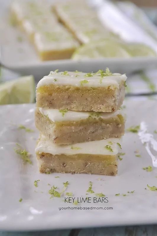 three pieces of cake sitting on top of a white plate next to limes and lemon wedges