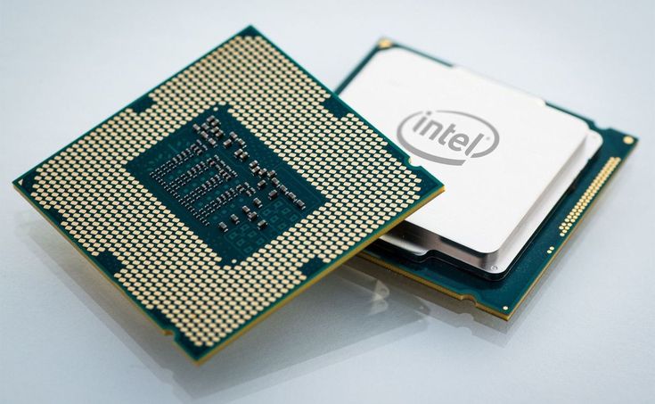 two cpus sitting next to each other on top of a white surface with the intel logo