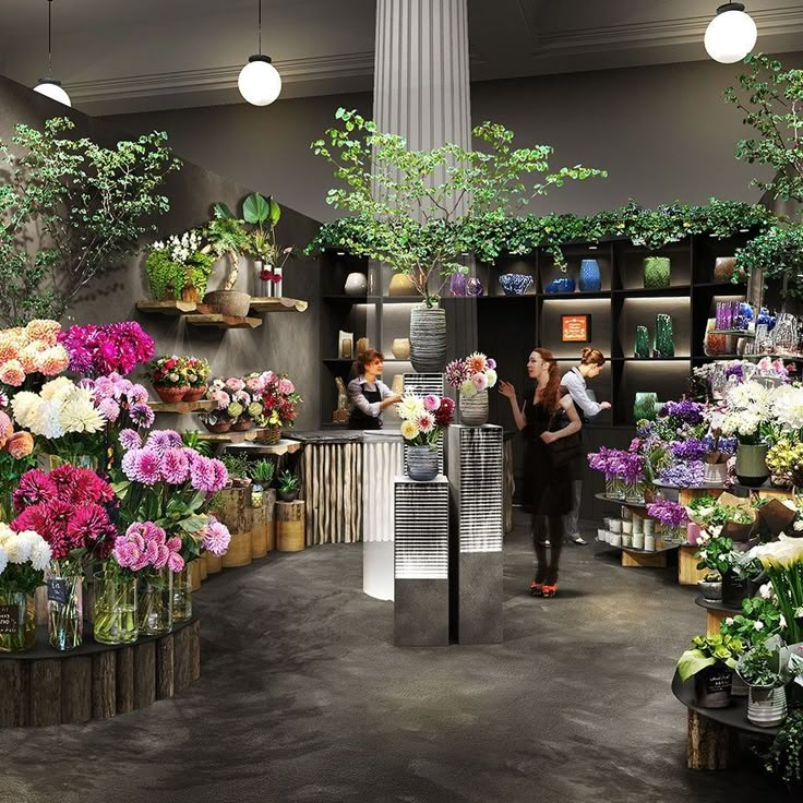 a woman standing in front of a flower shop filled with lots of different types of flowers