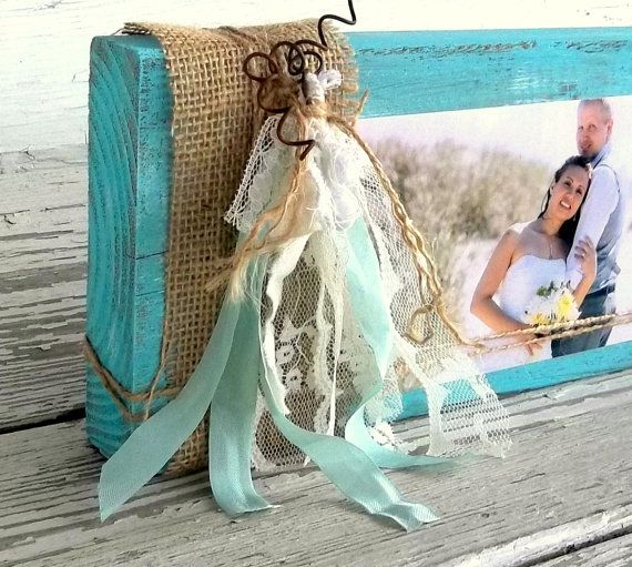 an old photo frame is decorated with burlap and lace for a rustic look