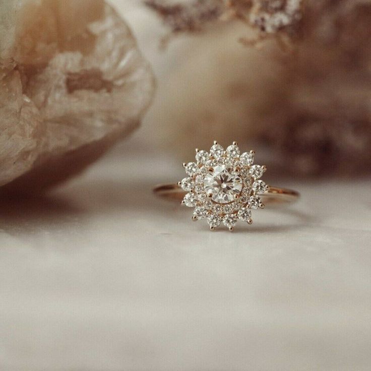 a diamond ring sitting on top of a rock