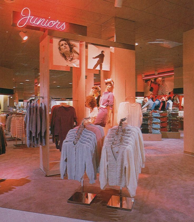 a clothing store with mannequins and shirts on display