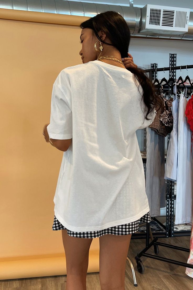 Also available in White with Red Bow. Product Deets White with black bow tee 100% cotton Boxy, oversized fit Bow graphics on chest Size small measures 22” in front, 24.5” in back Runs true to size Model Info Erielle is 5’1. Waist: 24" Bust: 32A Wearing size Small. Oversized Summer T-shirt, Chic Cotton T-shirt With Graphic Print, Chic Summer Streetwear T-shirt, Cotton Loungewear T-shirt, Basic Relaxed Fit Tops For Day Out, Short Sleeve Graphic Print Tops For Day Out, Graphic Print Short Sleeve Tops For Day Out, Crew Neck Tops For Day Out, Summer Loungewear T-shirt