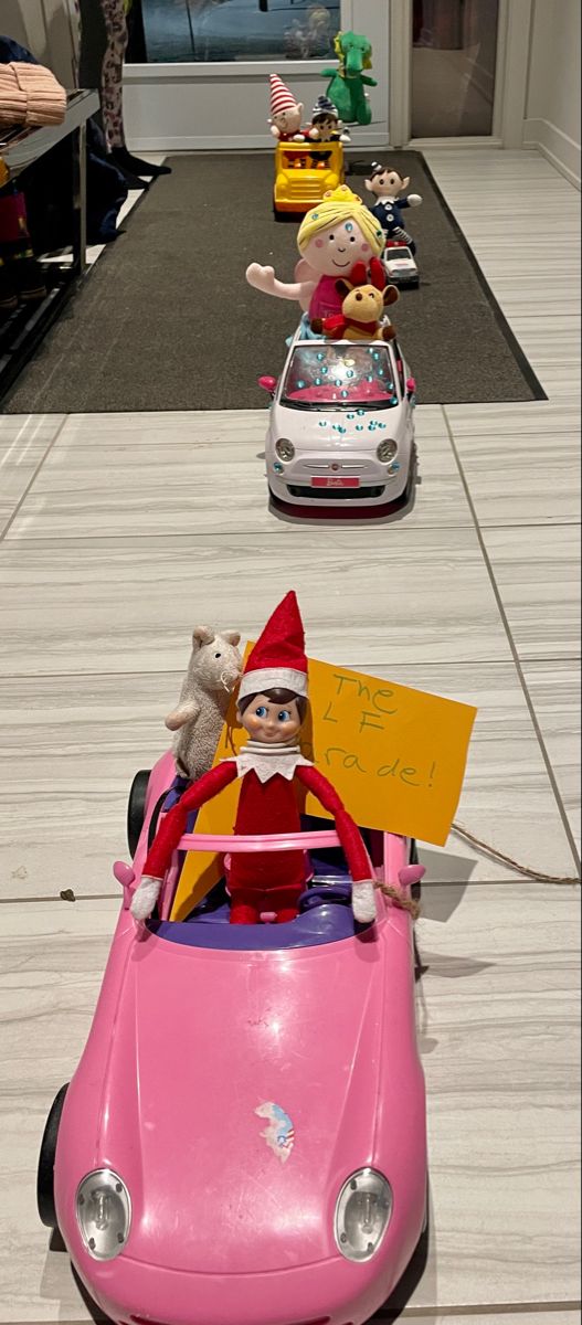 the elf is driving his toy car down the street