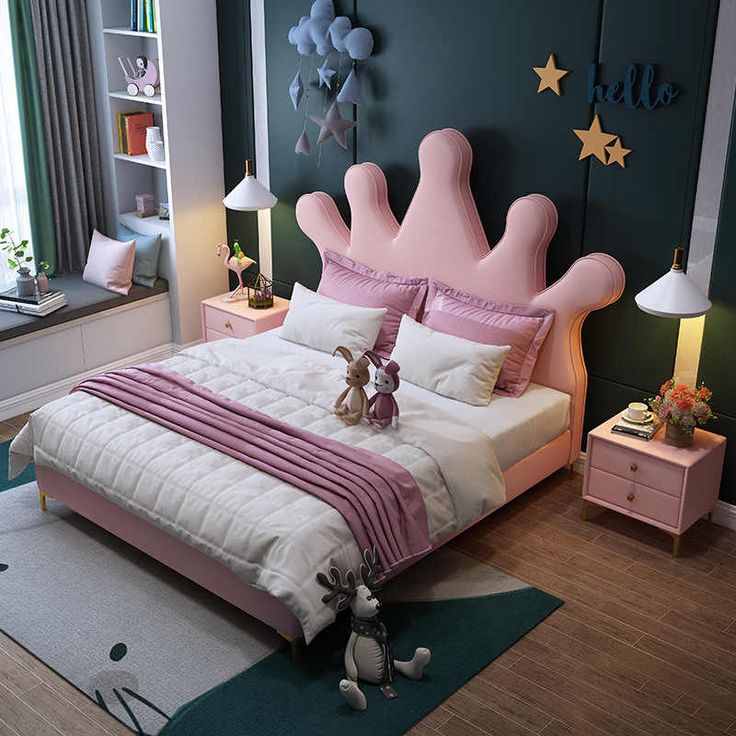 a bedroom decorated in pink, white and green with a princess's crown bed