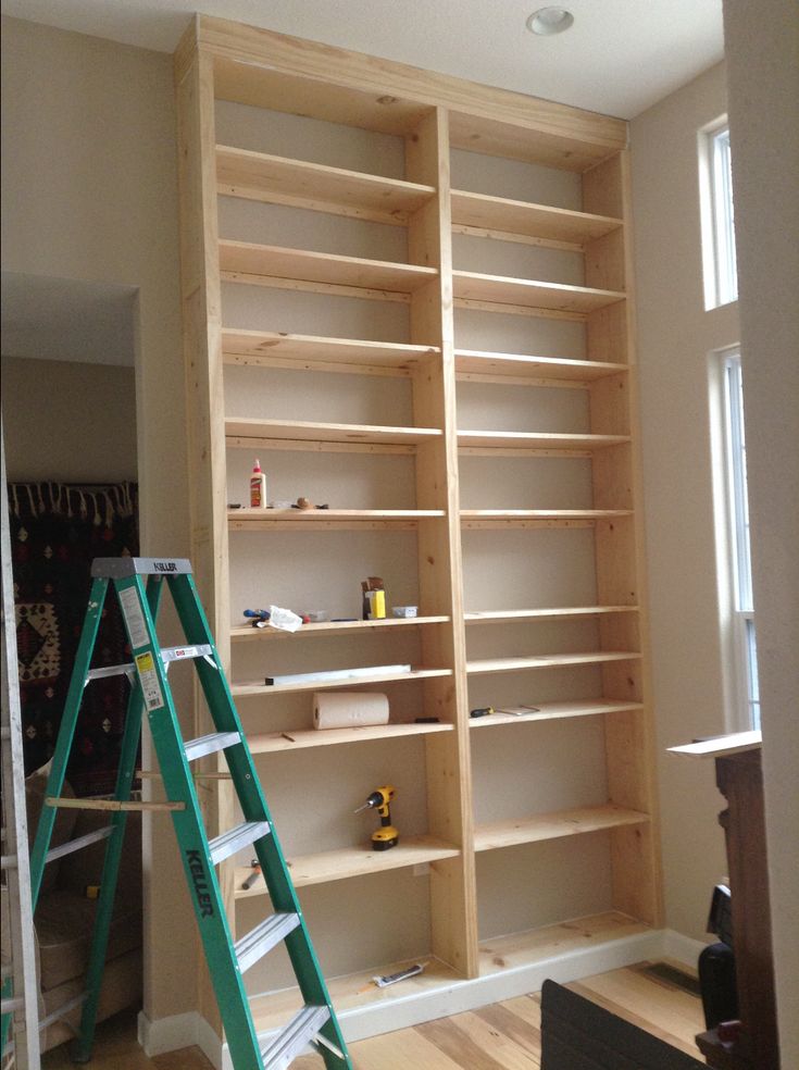 a ladder is in front of a bookshelf