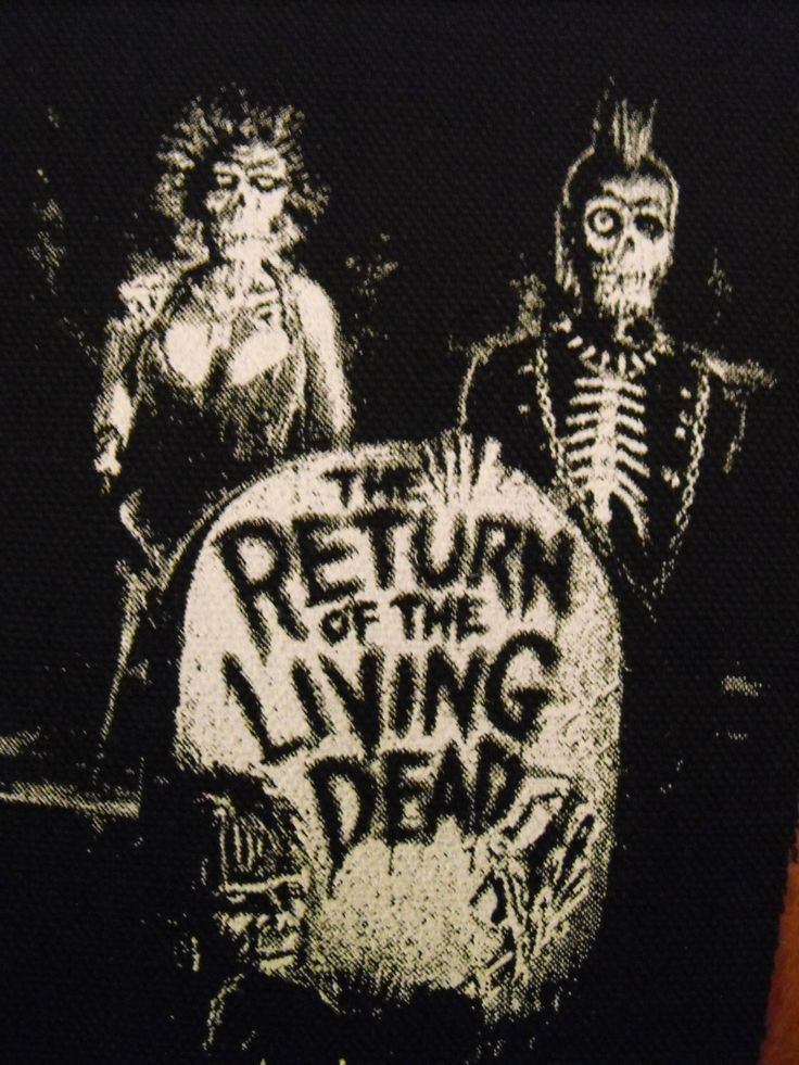 a black and white image of two skeletons holding a sign that says return to the living dead