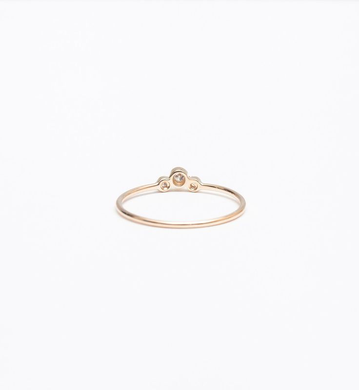 A slightly larger center and offset, delicate sides impart this delicate stacking ring with just the right amount of size and an unexpected silhouette. Though you can easily wear it on its own, you'll find a million ways to stack it thanks to the tiny space its curved design makes. Nestle it alongside other delicate rings for a multitude of sparkle or let it snuggle alongside a chunkier signet ring for maximum impact. Made in the U.S.A. Center setting measures 0.25" wide. 14 karat gold with thre Delicate Stacking Rings, Band Necklace, Vintage Engagement Rings Unique, Diamond Cluster Engagement Ring, Tiny Space, Cluster Engagement Ring, Engagement Ring White Gold, Bezel Ring, Wedding Bridal Jewellery