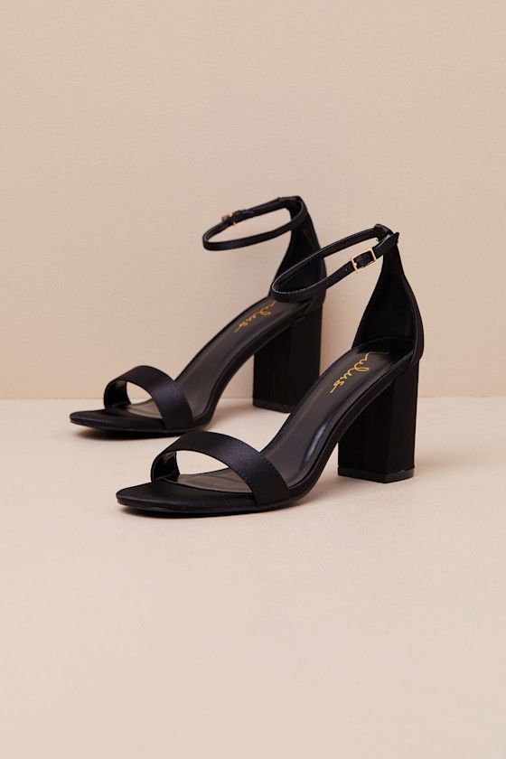 You're certain to step up your style essentials when you add the Lulus Arylee Black Satin Ankle Strap Heels to your closet! Sleek woven satin shapes a single toe strap, an almond-shaped toe bed, and a wrapped block heel. A dainty ankle strap rises from the sturdy heel cup and secures with a gold buckle. 3" Wrapped Block Heel. Cushioned Insole. Felted Rubber Sole Has Nonskid Markings. Man Made Materials. Imported. Lulus | Arylee Black Satin Ankle Strap Heels | Size 6. Elegant Fitted Block Heels For Night Out, Elegant Adjustable Block Heels, Chic Heels With Padded Heel And Adjustable Fit, Chic Adjustable Heels With Padded Heel, Fitted Open Toe Block Heels For Evening, Elegant Adjustable Heels With Stacked Heel, Satin Ankle Strap Sandals, Elegant Heels With Stacked Heel And Adjustable Fit, Elegant Heels With Adjustable Stacked Heel