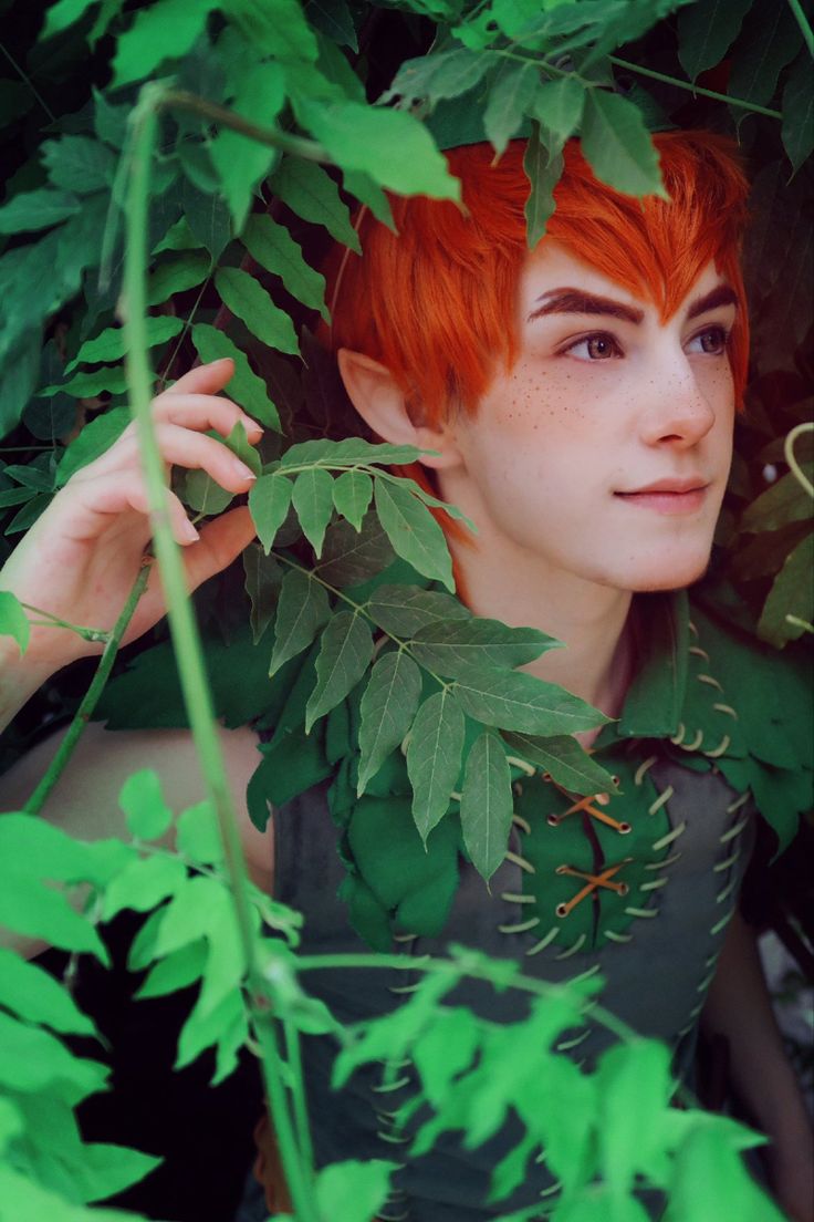 a woman with red hair and green leaves