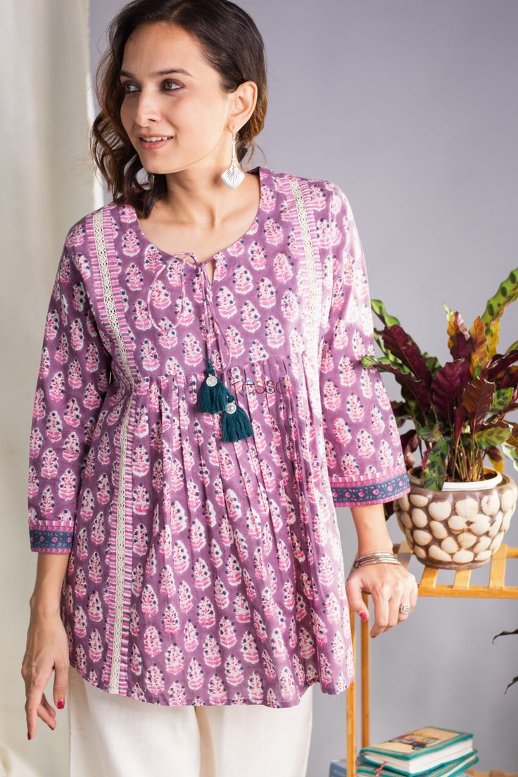 Sanjita cotton hand block printed fabric in hues of pastel shades, this short kurti is enhanced with front pleats. Perfect for casual Fridays at work, this short kurti can transition effortlessly from a work look to a casual look. Versatile and very comfy comes with front tussel and 3/4th sleeve. Pair this with our Cotton Salwar for perfect look. Short Cotton Frock For Women, Short Cotton Kurti, Cotton Kurti Design, Kurti Design Ideas, Cotton Frocks For Women, Cotton Short Kurti, Simple Dress For Girl, Short Kurti Designs, Cotton Short Tops