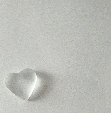 a white heart shaped object sitting on top of a table