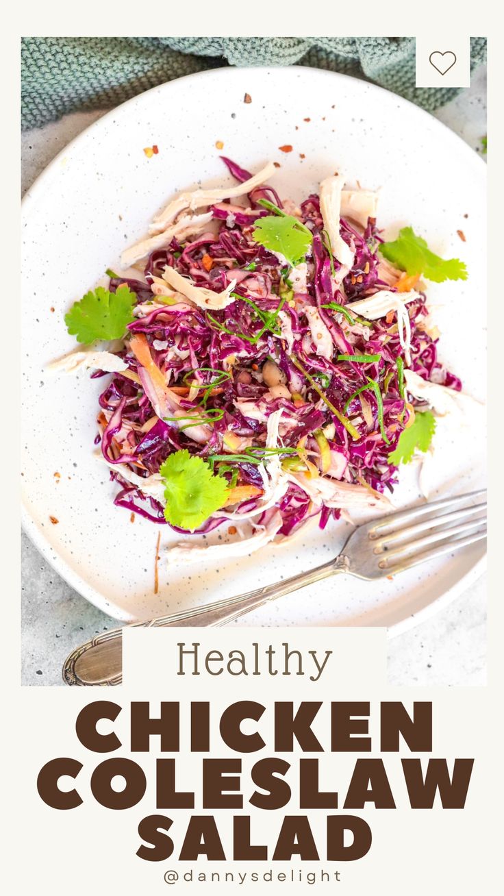 healthy chicken coleslaw salad on a white plate with a fork and napkin next to it