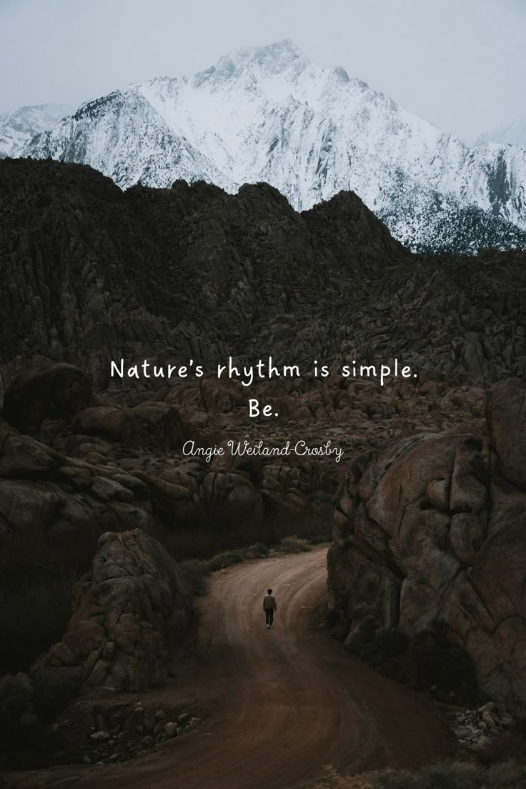 a person walking down a dirt road in front of mountains with the words nature's rhythm is simple be