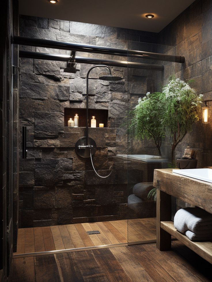 a bathroom with stone walls and wooden flooring next to a bathtub, shower head, and sink