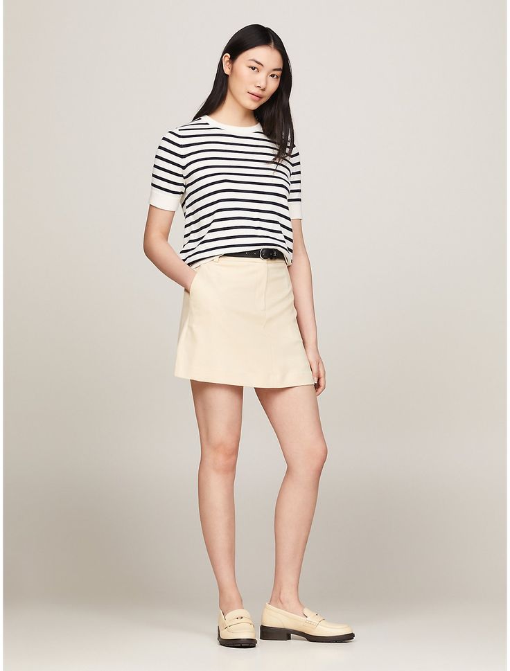 Tommy Hilfiger women's skirt. This mini skirt combines a playful silhouette with sophisticated details, such as understated logo embroidery above the back pocket.  Material: 66% Recycled Polyester (rpe), 32% Viscose (scv), 2% Elastane. Casual Lined Mini Skirt For Business Casual, Casual Business Mini Skirt Lined, Chic Mini Hem Shorts, Elegant Workwear Shorts With Lined Skirt, Tommy Hilfiger Mini Skirt For Spring, Tommy Hilfiger Spring Mini Skirt, Summer Workwear Mini Hem Skort, Summer Workwear Mini Skort, Lined Skirt For Business Casual In Summer