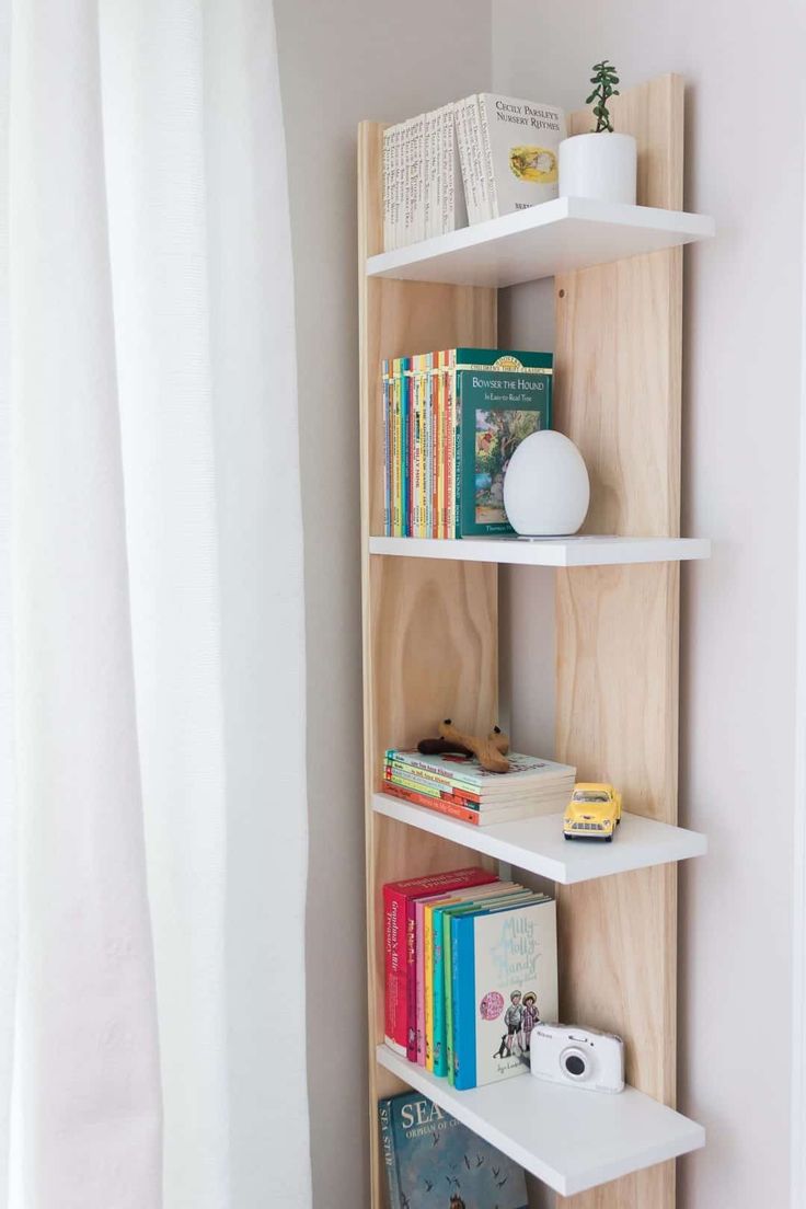 the bookshelf is made out of wood and has three shelves