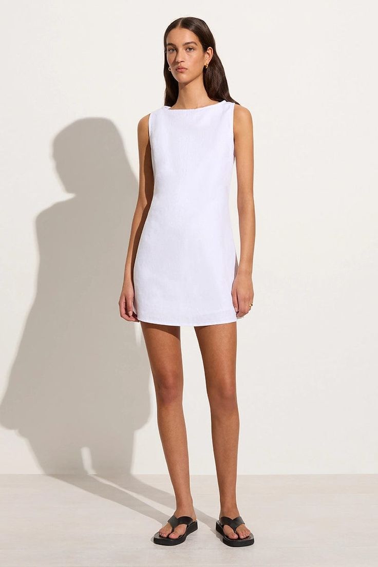 In responsibly sourced European Flax® linen, the Lui Mini Dress in White is a modern take on the classic summer mini. It features a high boat neckline, relaxed A-line silhouette and back waist ties with a twist detail to cinch as desired. Lined throughout for extra coverage. Summer Wardrobe Staples, Designer Clothing Brands, White Linen Dresses, Mini Dress White, Maxi Dress Sale, Grad Dresses, Faithfull The Brand, Glamour Fashion, Sleeveless Mini Dress